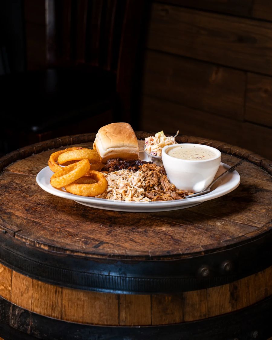 Combo Platter of slow-smoked meats on a barrel table at Hop N Grape in Longview, WA